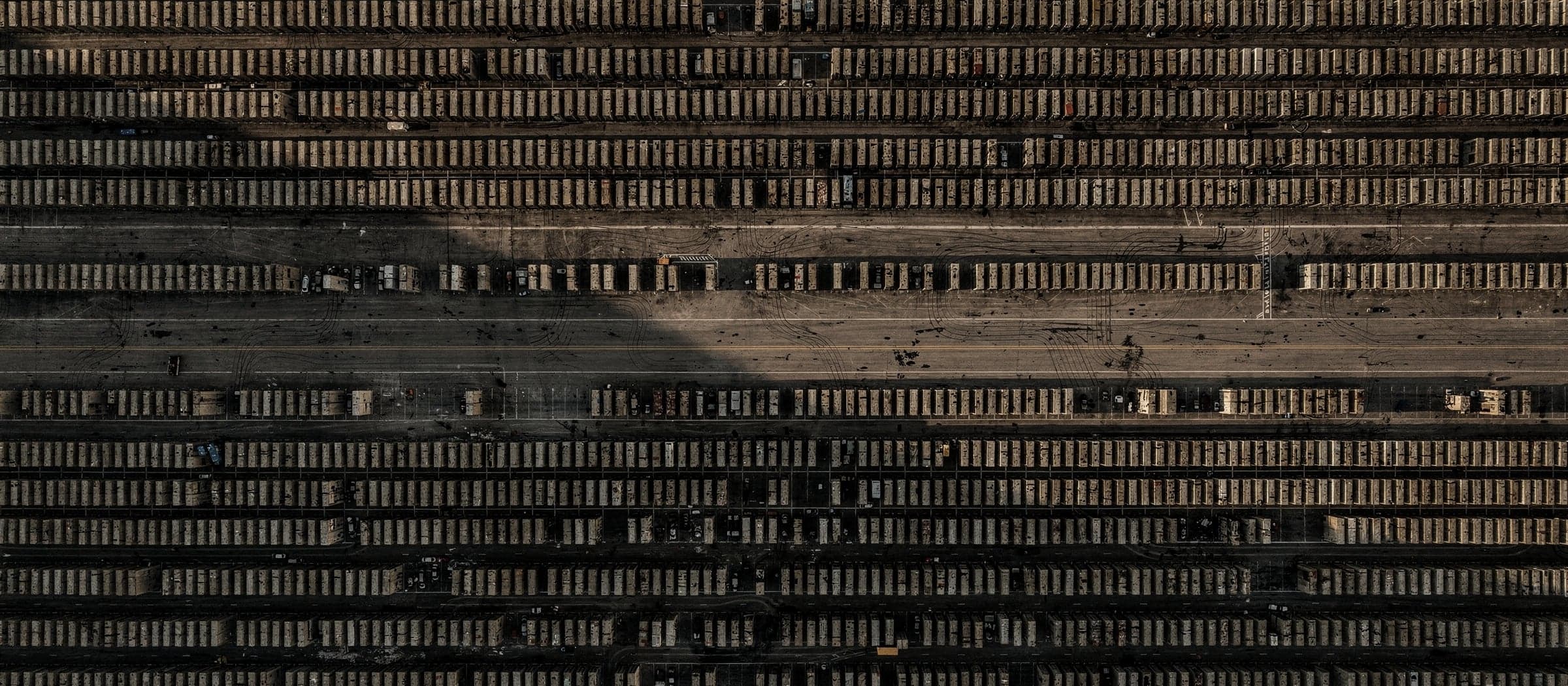 Vista aérea de un patio logístico con contenedores alineados en una cuadrícula perfecta
